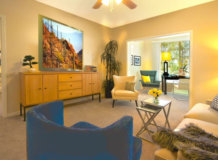 Well-decorated living area with a ceiling fan in a model senior apartment at Casa Del Rio Senior Living in Peoria, Arizona