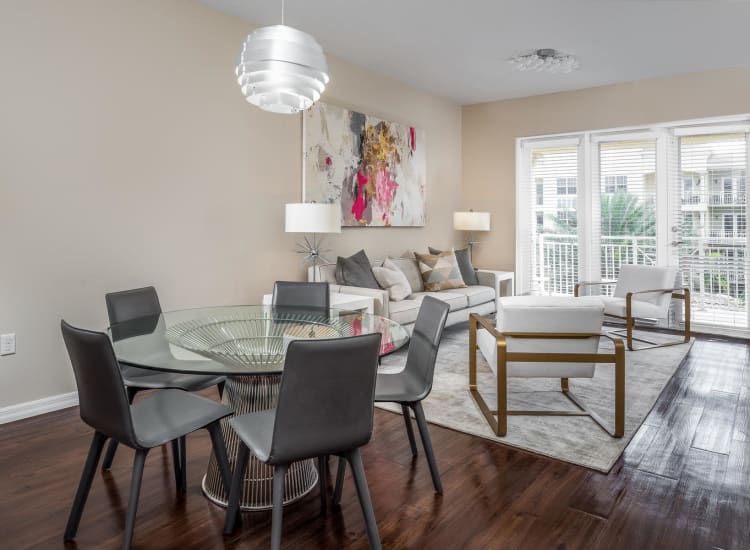 Hardwood floors in the dining and living areas in a model senior apartment at Riverwalk Pointe in Jupiter, Florida