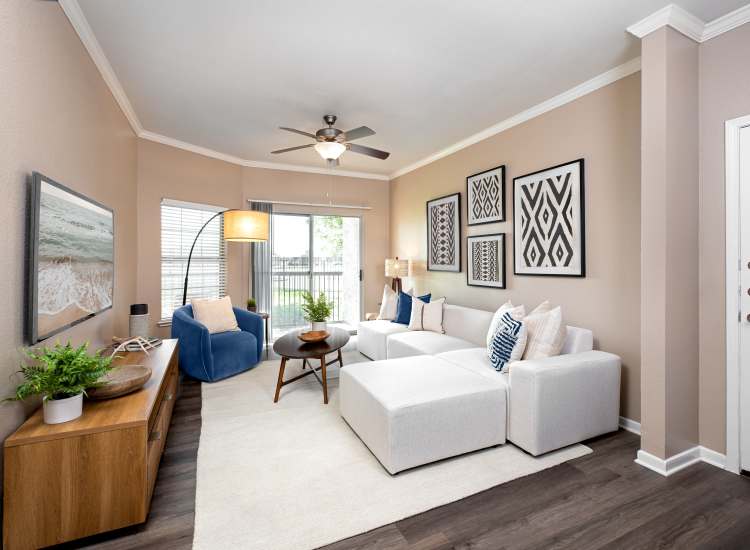 Living room with ceiling fan Crescent Cove at Lakepointe