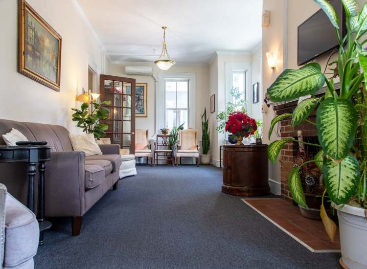 Living room with black carpet flooring at Hearth at Burroughs in Jamaica Plain,Massachusetts