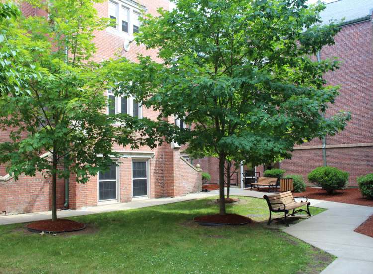 Property exterior with a lawn at School House Brookledge Cummins in Mattapan,Massachusetts