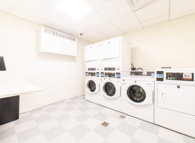 Women putting clothes into the washer at Hawthorne Lofts in Salem, Massachusetts