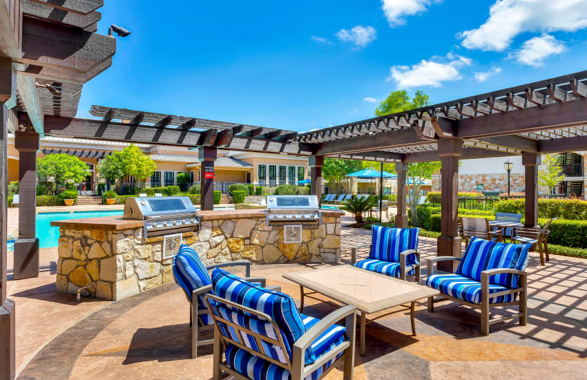 BBQ area by the pool at Onion Creek Luxury Apartments in Austin, Texas