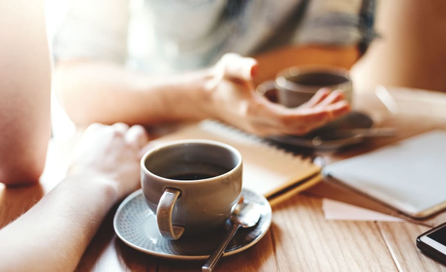 Resident starting the day with hot coffee in a local cafe near Residences at 8 East Huron in Chicago, Illinois