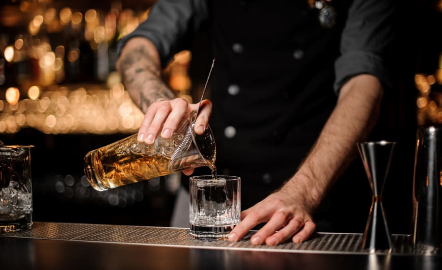 Bartender mixing a drink near Residences at 8 East Huron in Chicago, Illinois
