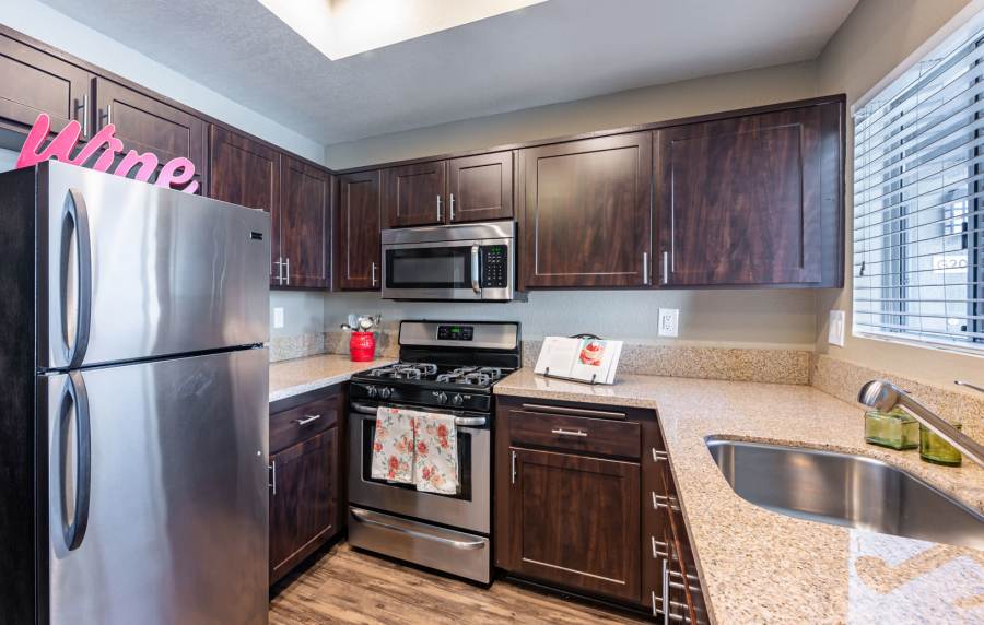  Modern kitchen with wooden cabinets at Seapointe Villas in Costa Mesa, California