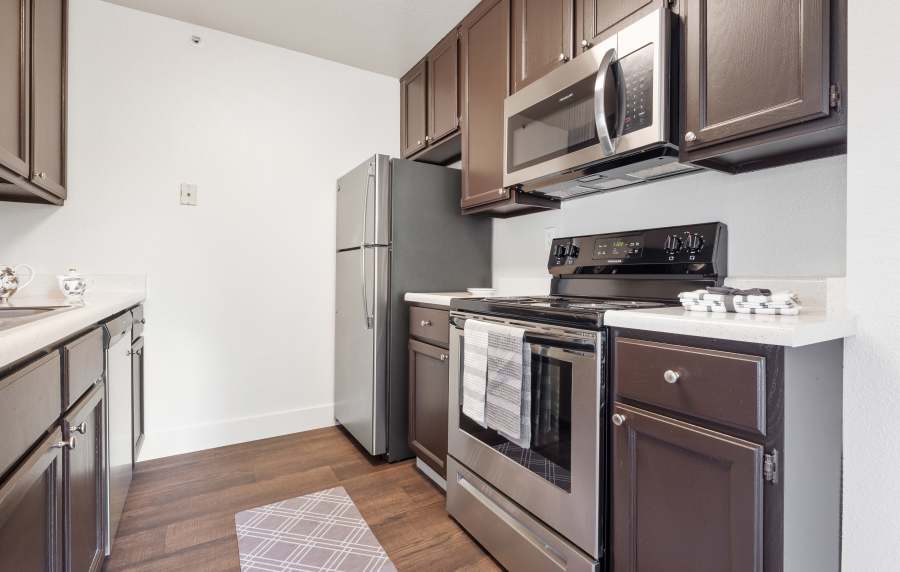 Kitchen with wooden cabinets at La Vina Apartments in Livermore, California,  