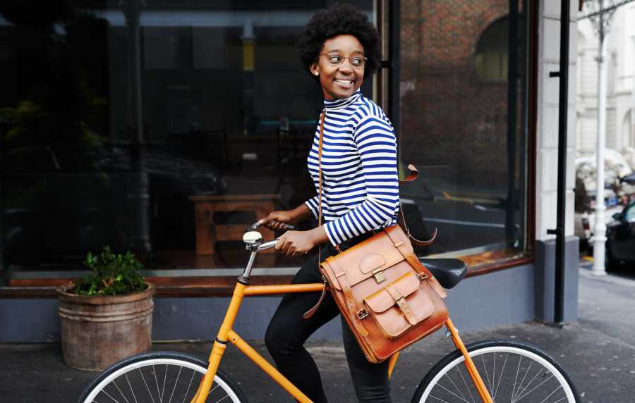 Woman alanong with her bike in downtown not far from The Bluffs in Rancho Cucamonga, California,