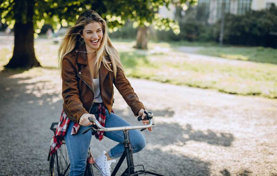 Resident riding bicycle in park near Bridges at San Ramon in San Ramon, California,