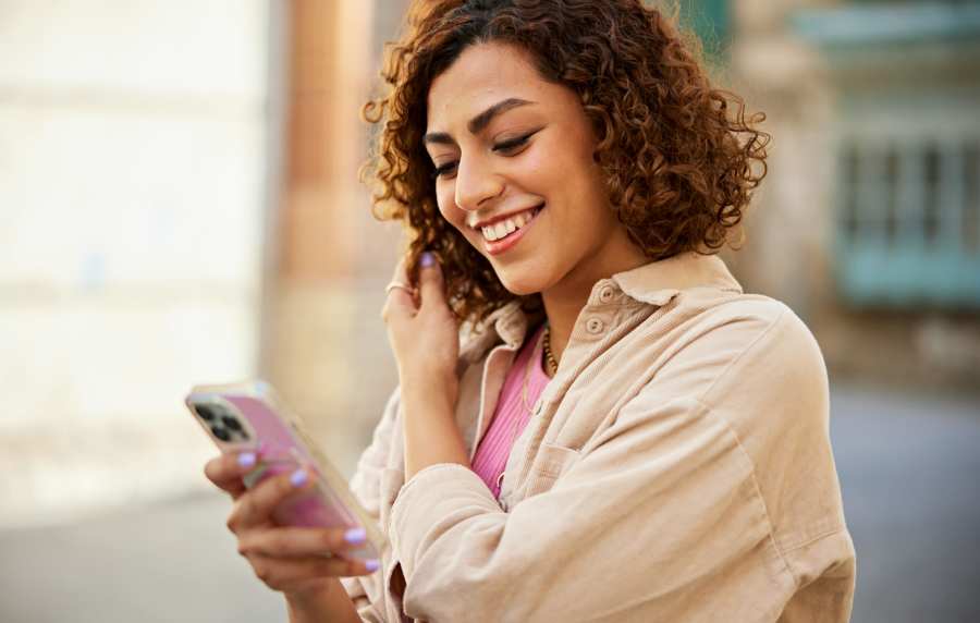 Woman using her phone at Luxe @ Ocotillo in Chandler, Arizona, 