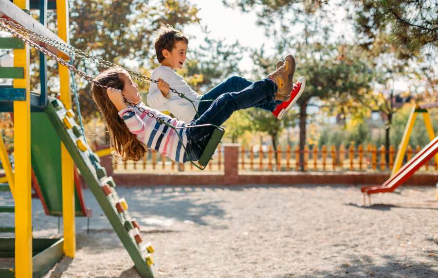 Kids on a swing at a playground near Emerald Place in Lancaster, Ohio
