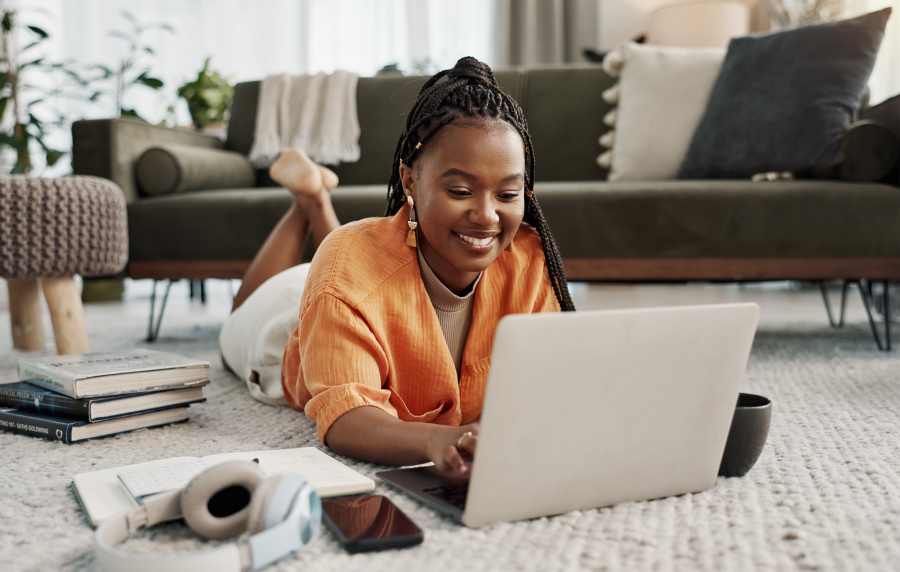 Resident in the apartment using her laptop at Oldham & Worth in Raleigh, North Carolina