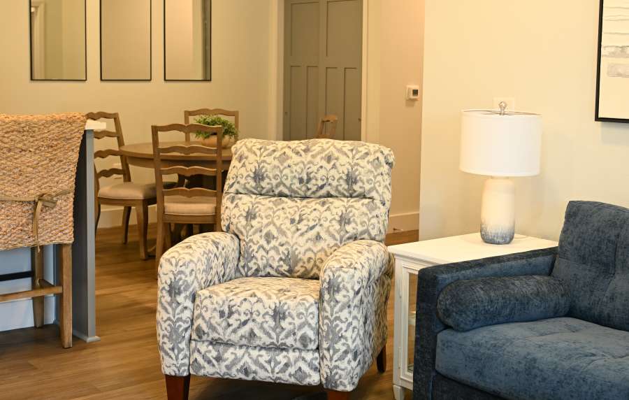 Living room with sofa and side lamp at Anchor Apartments in Freeport, Florida
