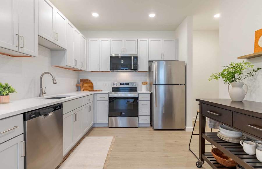 Stylish kitchen with stainless-steel appliances and white cabinets at The Ramsay in Springdale, Arkansas