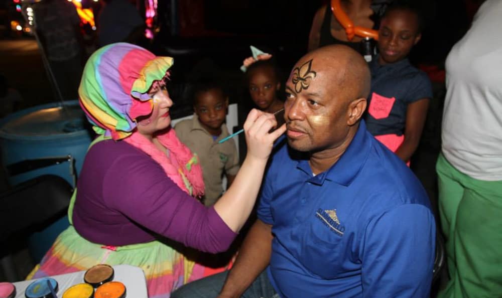Resident getting his face painted at Emerald Pointe Apartment Homes in Harvey, Louisiana