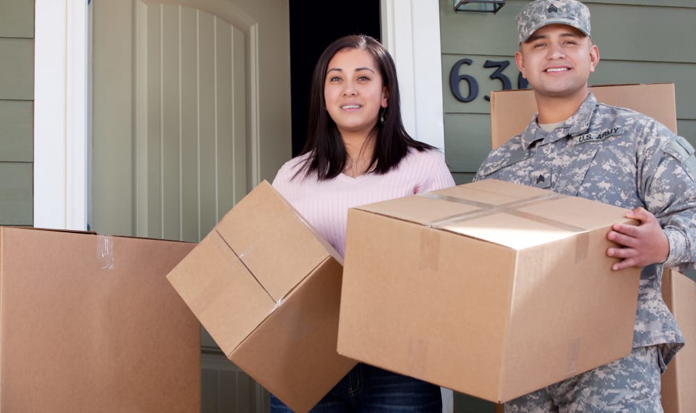 Military man and his girlfriend carrying boxes to Fairmont Storage