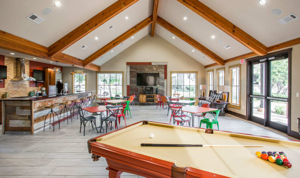 Resident clubhouse with a billiards table and more at Riata Austin in Austin, Texas