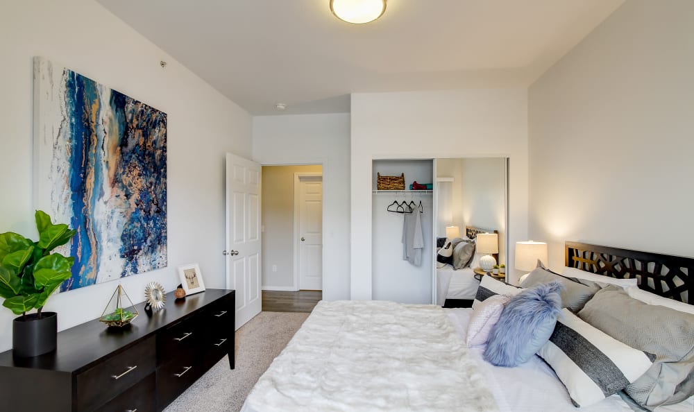 Well-decorated master bedroom in a model home at River Trail Apartments in Puyallup, Washington