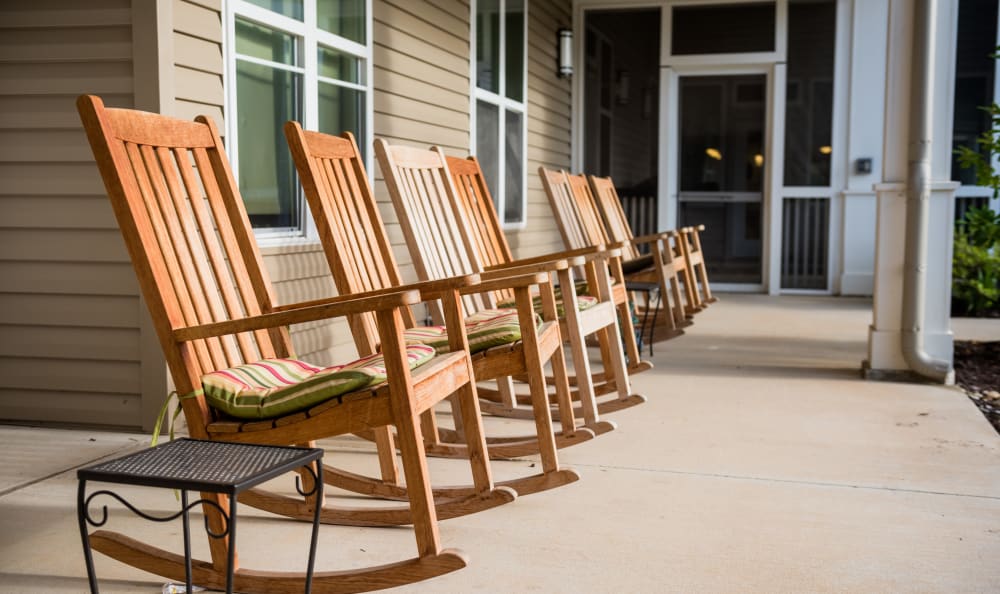 Rocking chairs outside at Clear Creek Memory Care in Fayetteville, Arkansas
