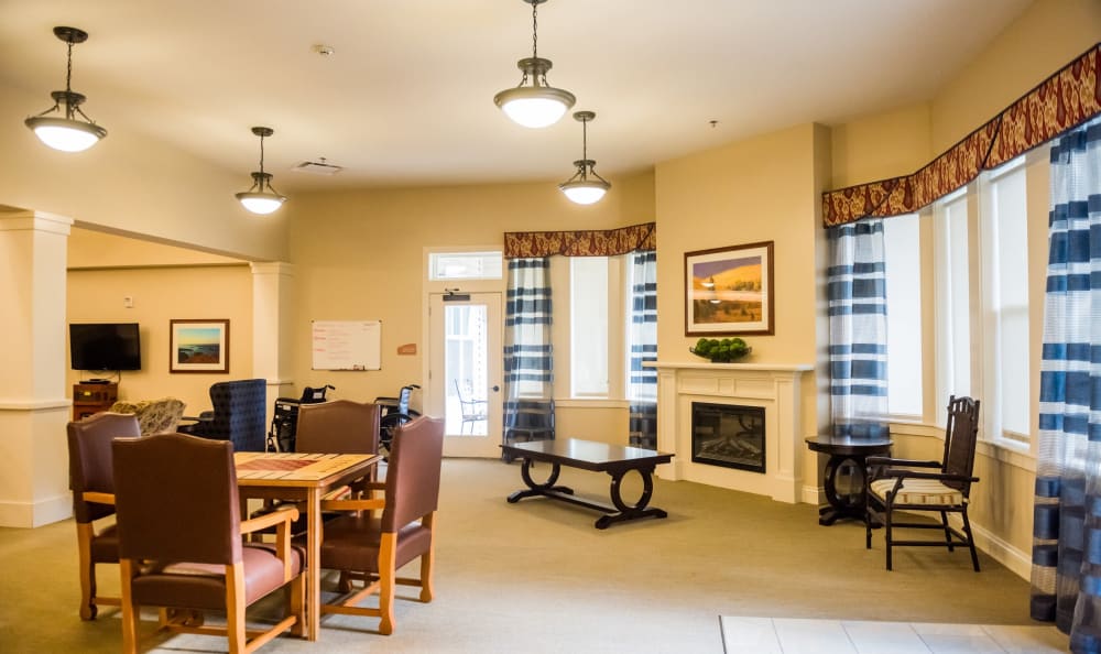 Activity room with a fireplace at Clear Creek Memory Care in Fayetteville, Arkansas