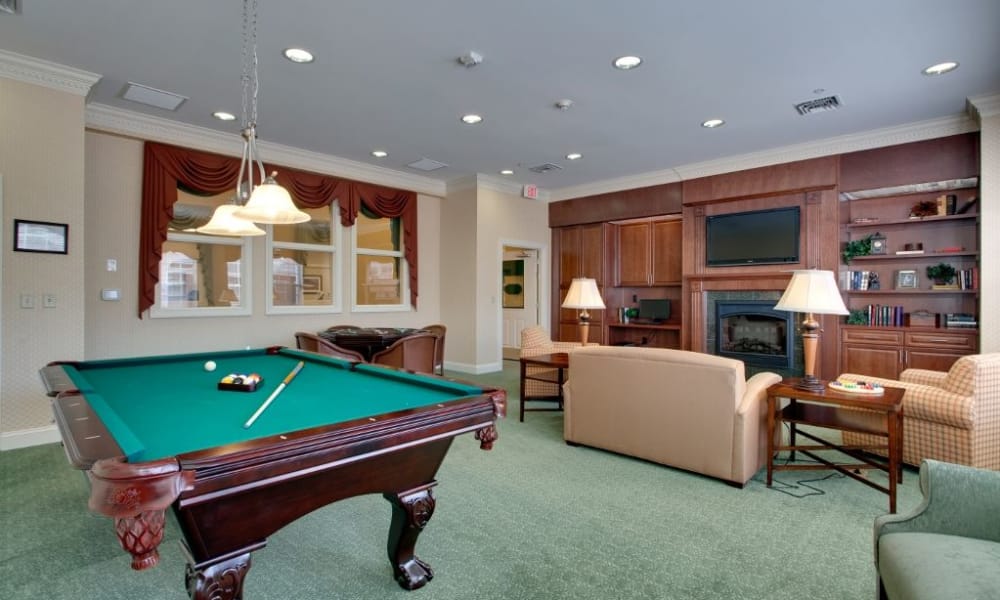 Game room with pool table at Waltonwood Cary Parkway
