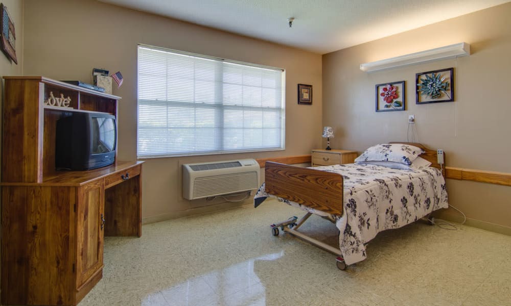Single bedroom with a television at Moran Manor in Moran, Kansas