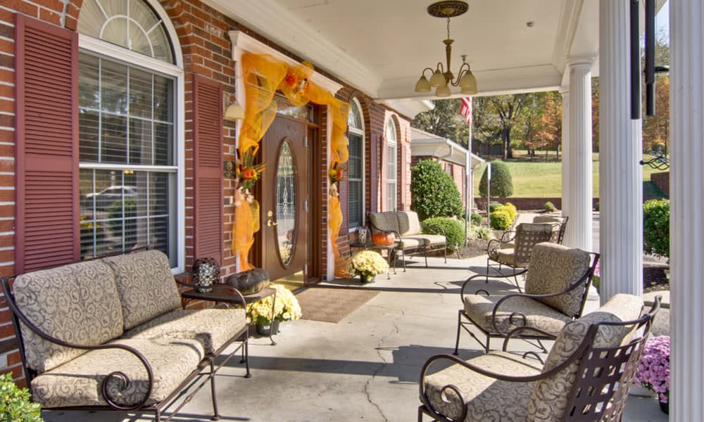 Front porch with covered seating at Asbury Cove in Ripley, Tennessee