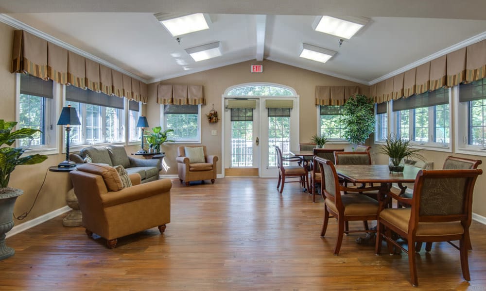 Community lounge with tables and comfortable seating at Riverview Terrace in McMinnville, Tennessee