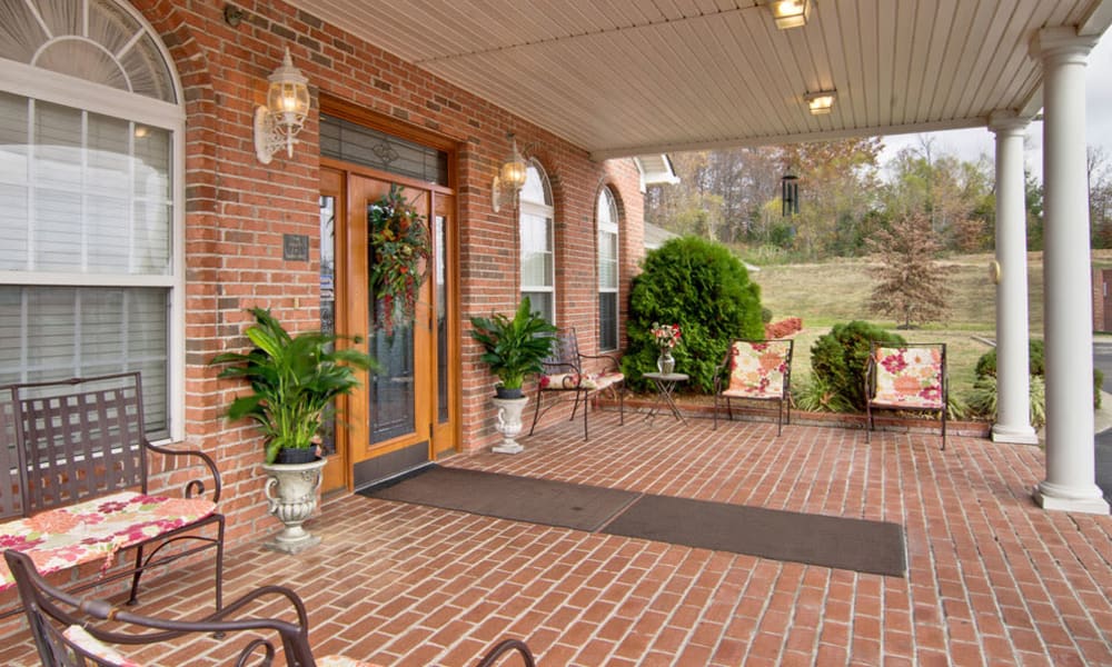 Front porch with covered seating at Harmony Hill in Huntingdon, Tennessee