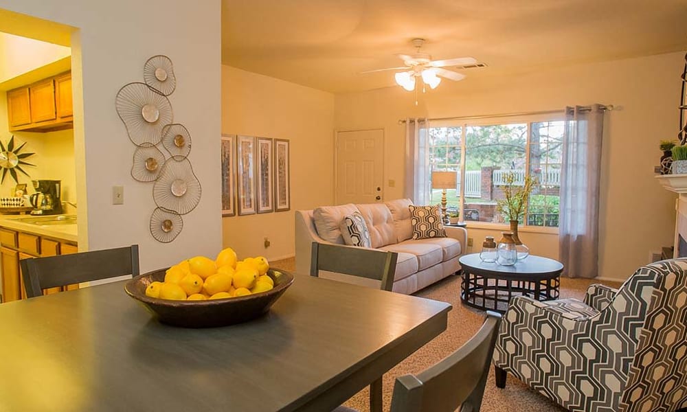 An apartment dining room and living room at The Courtyards in Tulsa, OK