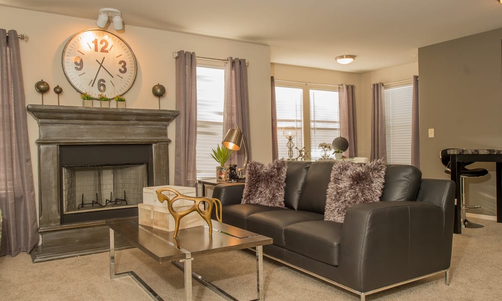 Spacious living room with a fireplace at Cottages at Tallgrass Point Apartments in Owasso, Oklahoma