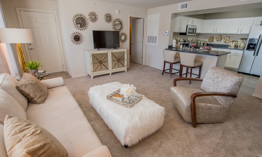 Well decorated living room with plush carpeting at Cottages at Tallgrass Point Apartments in Owasso, Oklahoma