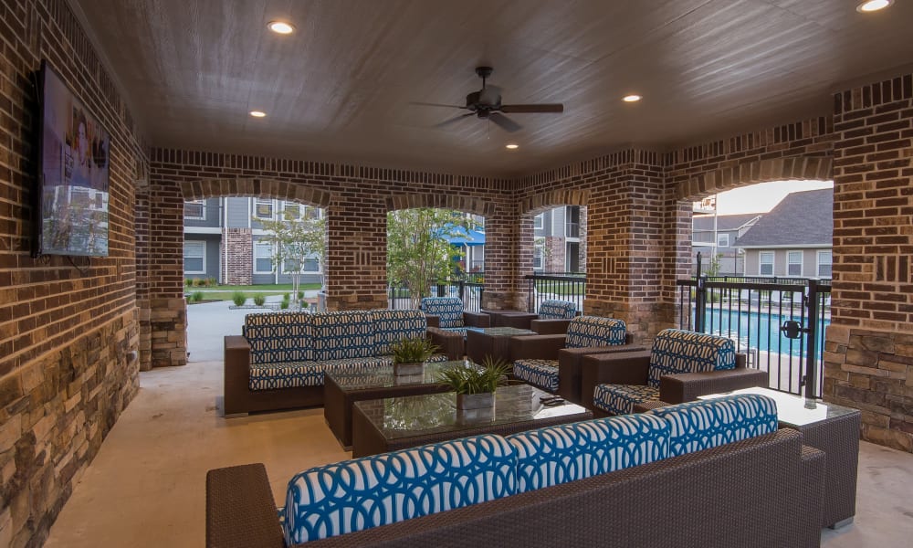 Exterior seating area by the pool at Cottages at Tallgrass Point Apartments in Owasso, Oklahoma