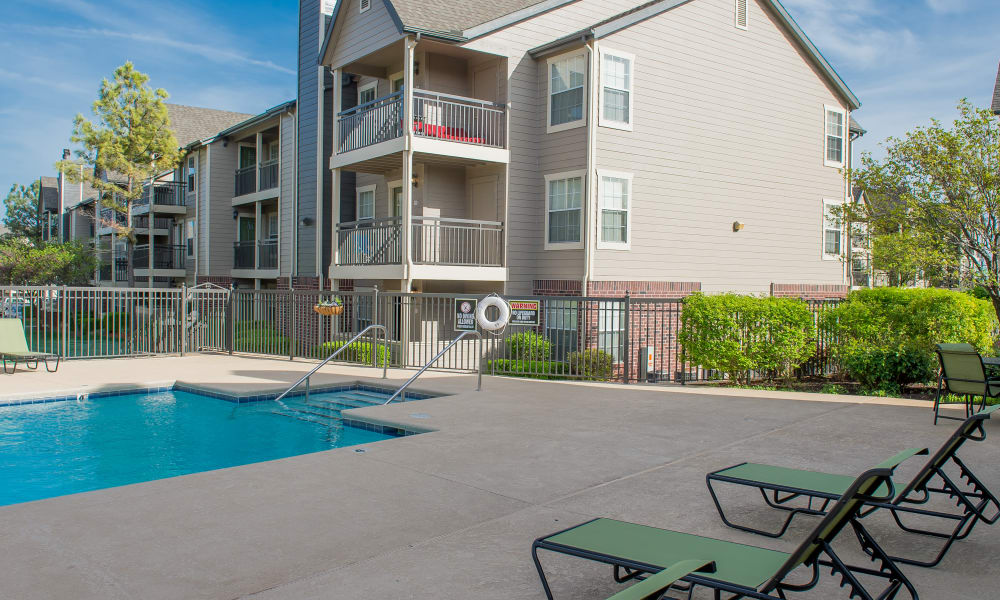Lounge chairs by the pool at Crown Pointe Apartments in Oklahoma City, Oklahoma