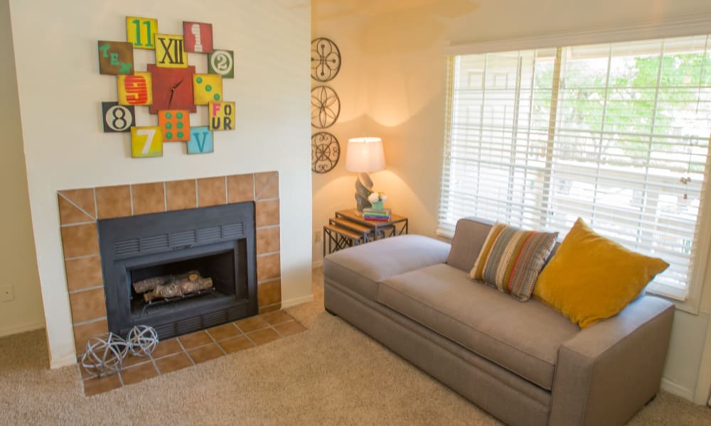 An apartment living room with fireplace at Chardonnay in Tulsa, OK