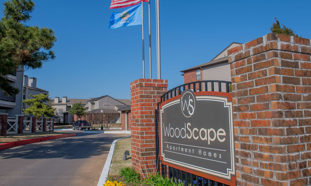 The sign in front of Woodscape Apartments in Oklahoma City, OK