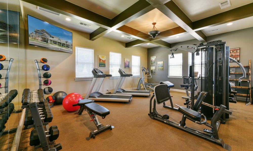Fully equipped gym for residents at Cottages at Abbey Glen Apartments in Lubbock, Texas