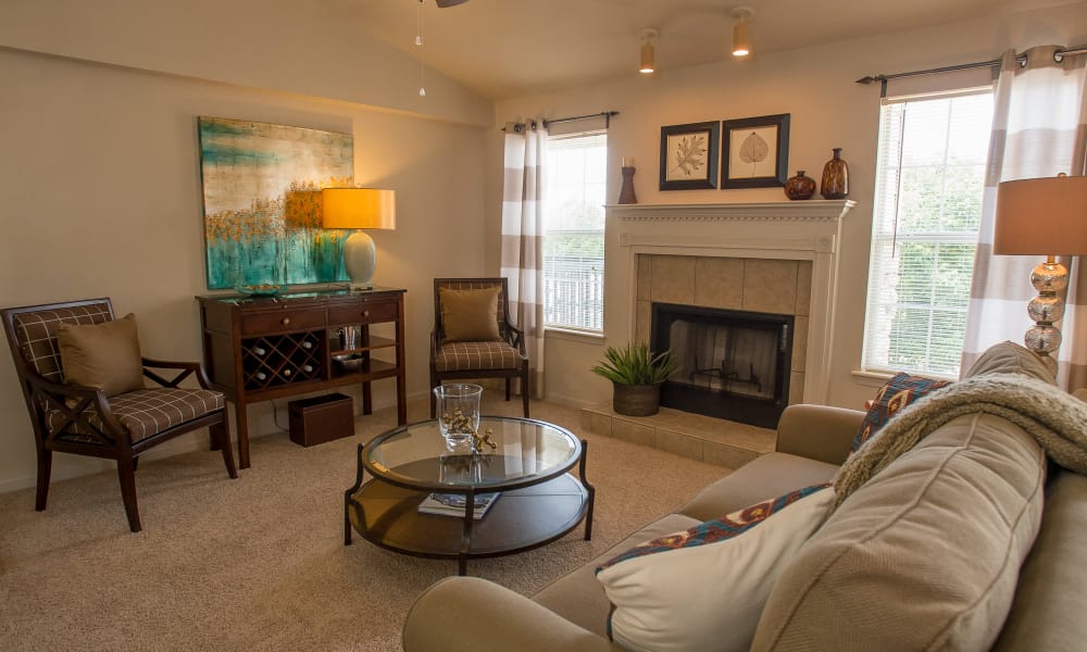 An apartment living room with fire place at Villas at Stonebridge in Edmond, Oklahoma
