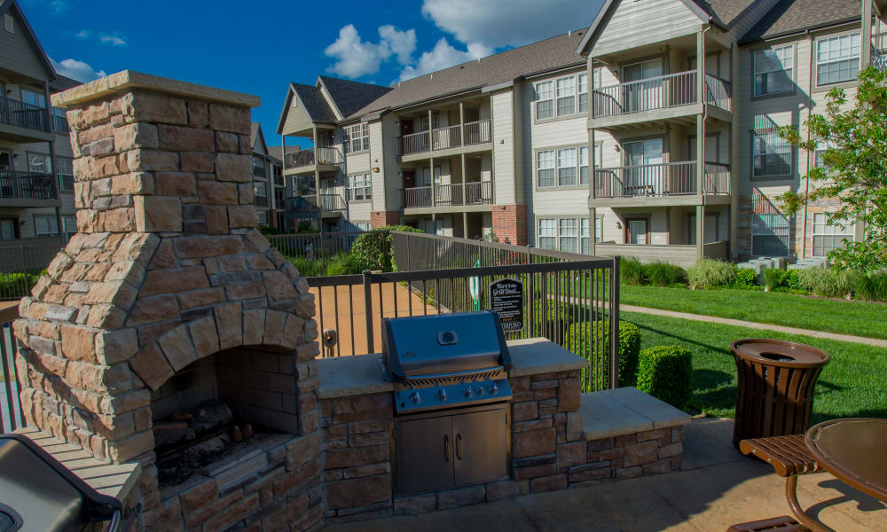 Outdoor patio with a fireplace at Villas of Waterford Apartments in Wichita, Kansas