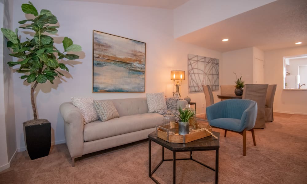 An apartment living room with couch and table at The Trace of Ridgeland in Ridgeland, MS