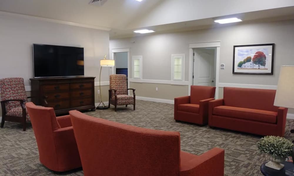 Entertainment room with a tv and seating at The Arbors at Harmony Gardens in Warrensburg, Missouri