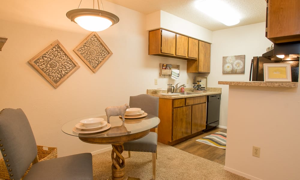 An apartment dining room and kitchen at Cimarron Pointe Apartments in Oklahoma City, OK