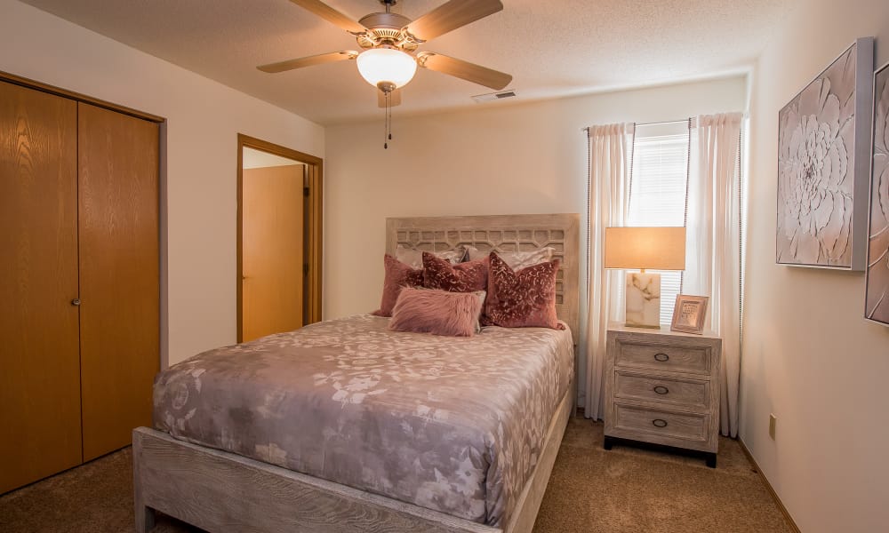 Bedroom with a ceiling fan at Huntington Park Apartments in Wichita, Kansas