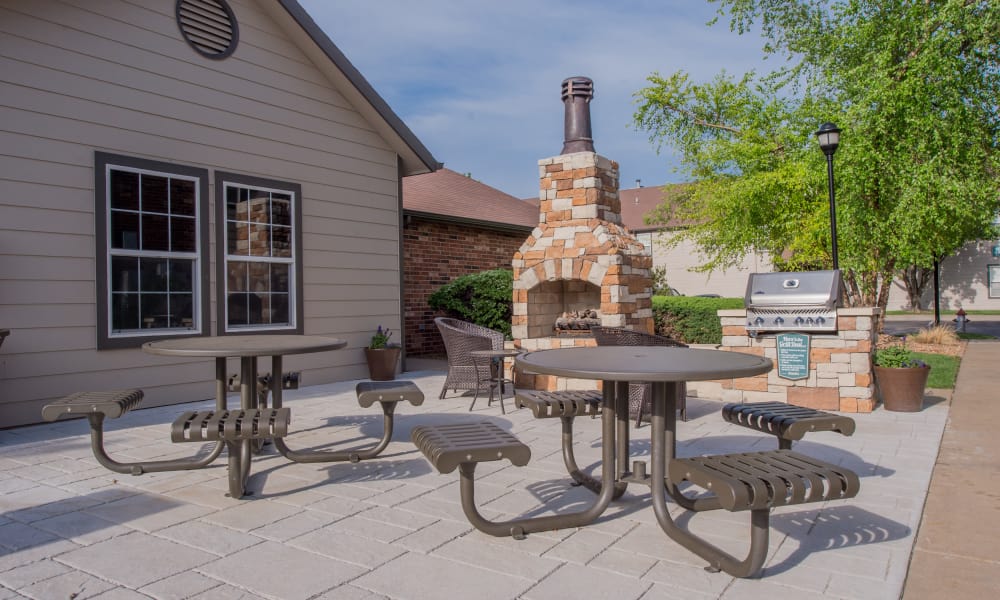 Outdoor patio with a grill at Huntington Park Apartments in Wichita, Kansas
