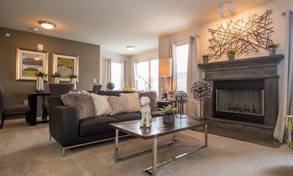 Cozy living room with fireplace at Scissortail Crossing Apartments in Broken Arrow, Oklahoma