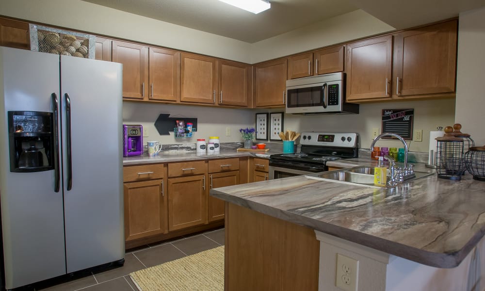 Kitchen with granite counters and stainless steel appliances at Portofino Apartments in Wichita, Kansas