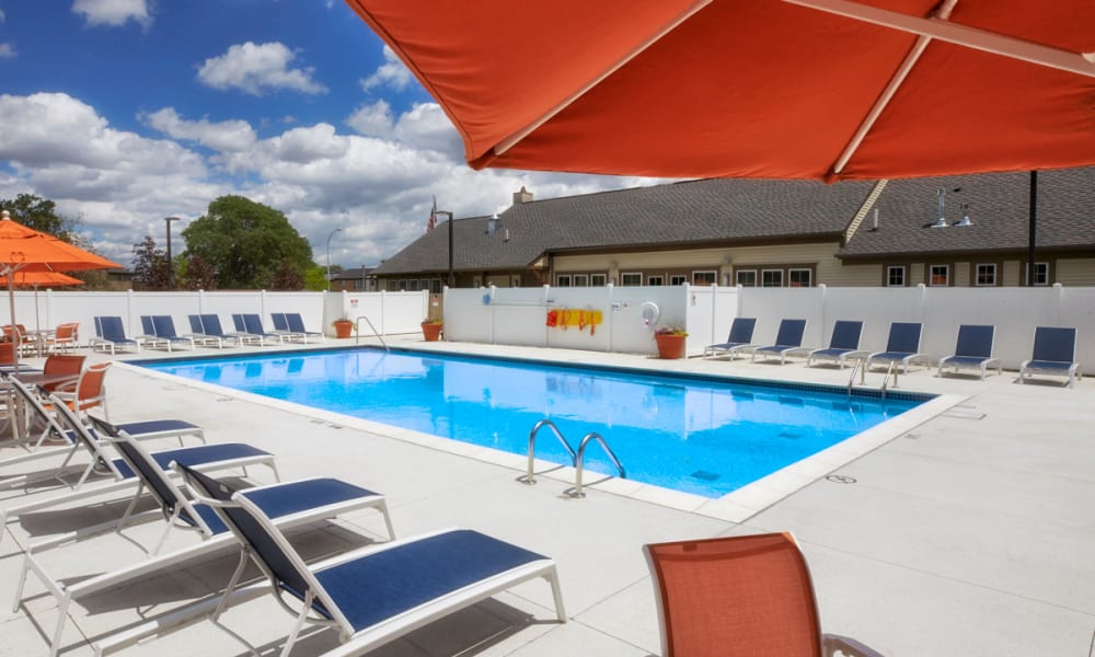 Swimming pool on a sunny day at President Madison Apartments in Madison Heights, Michigan