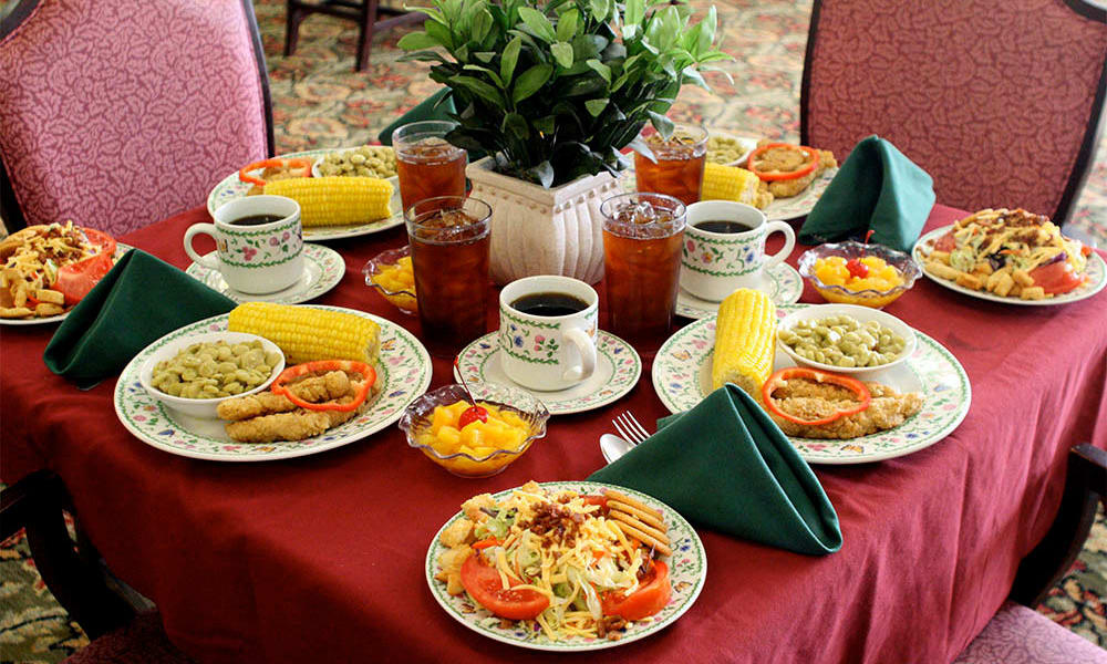 Freshly prepared meals on a community dining table at Heritage Green Assisted Living and Memory Care in Lynchburg, Virginia