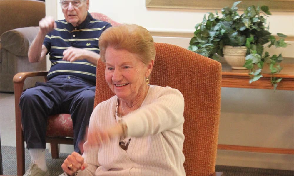 Resident playing a game and smiling at Heritage Green in Mechanicsville, Virginia