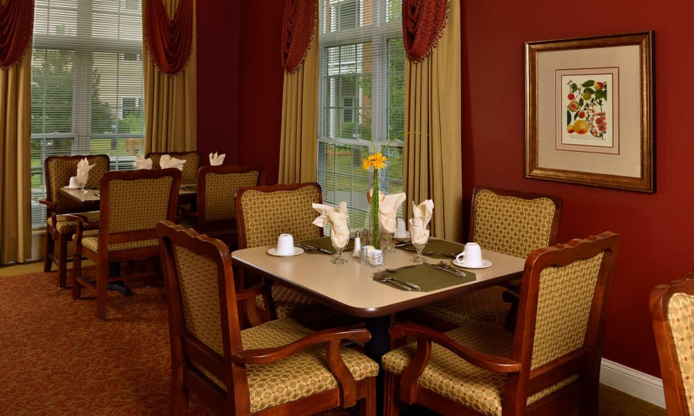 Small dining table in front of a wall with art at Keystone Commons in Ludlow, Massachusetts